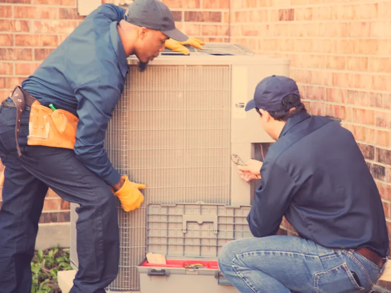 techs working on an hvac unit